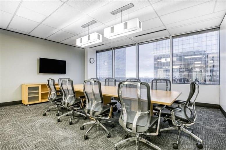 Spacious boardroom at 12 Greenway Plaza, Suite 1100 with city views and ergonomic mesh chairs.