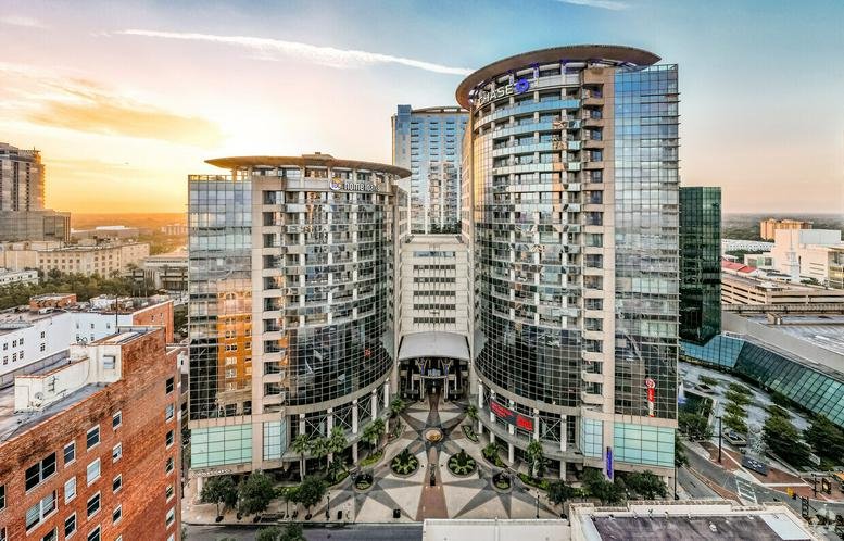 Symmetric exterior view of the modern glass towers at 121 S Orange Avenue, North Tower.
