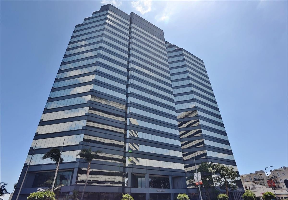 The modern glass and steel exterior of 12100 Wilshire Boulevard.