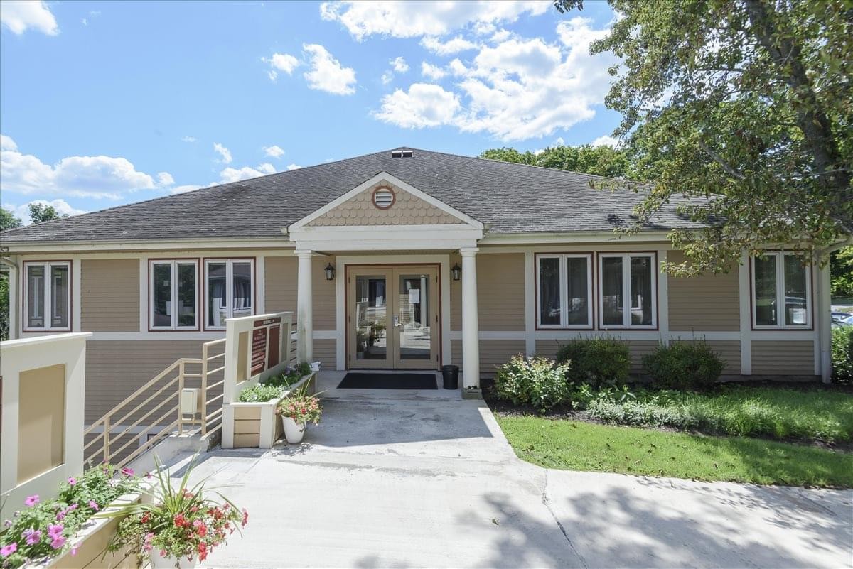Exterior view of the tan building at 1224 Mill Street, Mill Crossing Office Park.