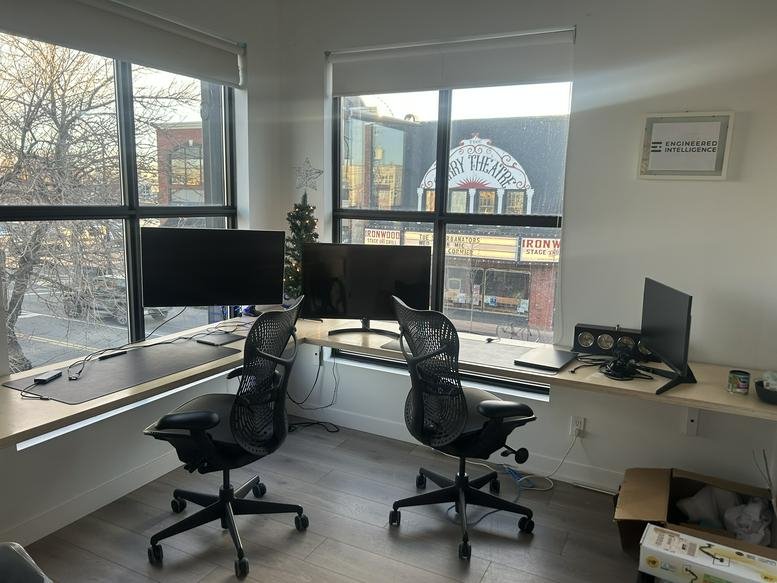 Spacious dual workstation at VennYYC Coworking Space, Inglewood, Calgary with large windows and city views.