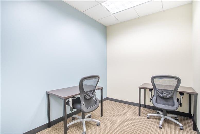 Private office suite with two desks and light blue accent wall.