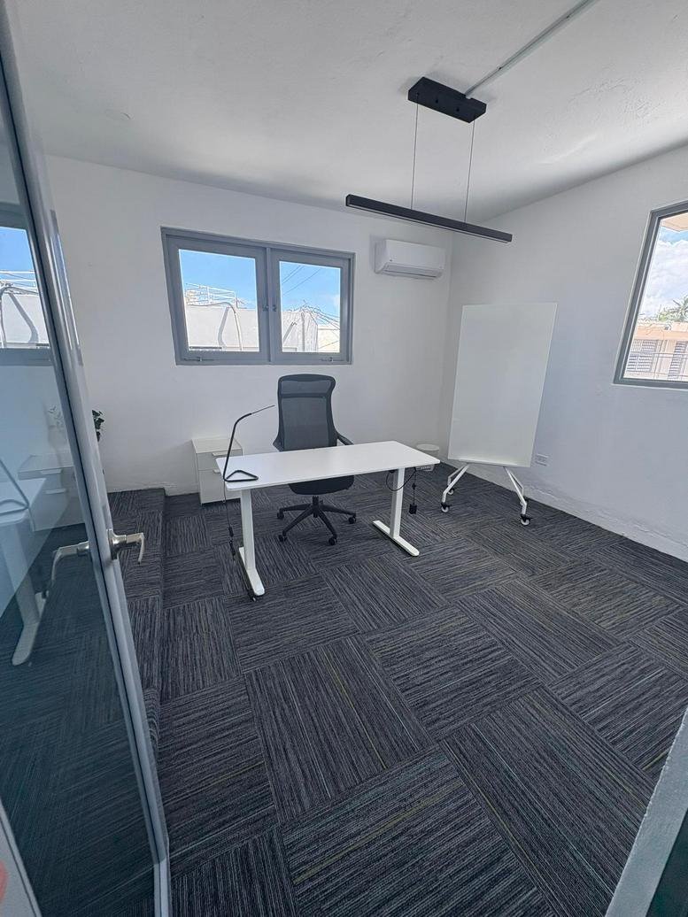 Spacious private office at 126 Calle Marginal South, Hato Rey with white desk, ergonomic chair and whiteboard.