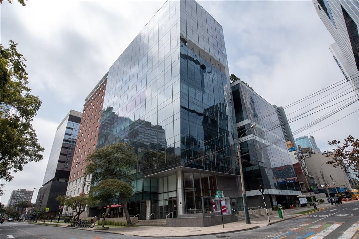 Exterior view of the modern glass-facade Fibra Building in San Isidro.
