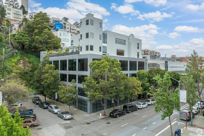 Exterior view of the multi-story Werqwise Telegraph Hill, Sansome Street building with large glass windows.