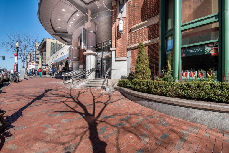 Exterior view of the red brick building at 131 Dartmouth St featuring a curved glass entrance.