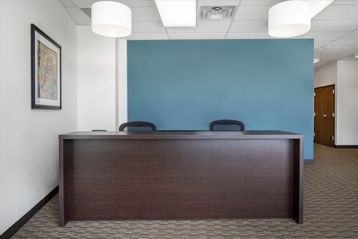Dark wood reception desk at 1320 Central Park Boulevard. , Suite 200, Central Park Corporate Center.