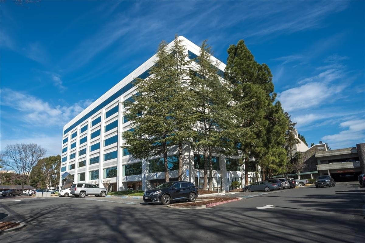 Exterior view of the multi-story glass and white facade at 1320 Willow Pass Road.