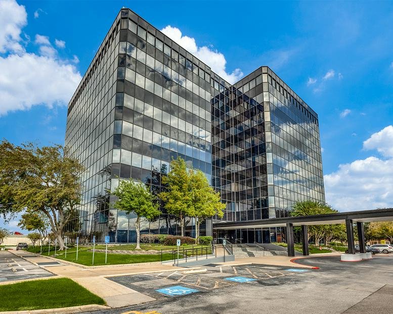 Exterior view of the glass-facade office building at 13201 Northwest Freeway.