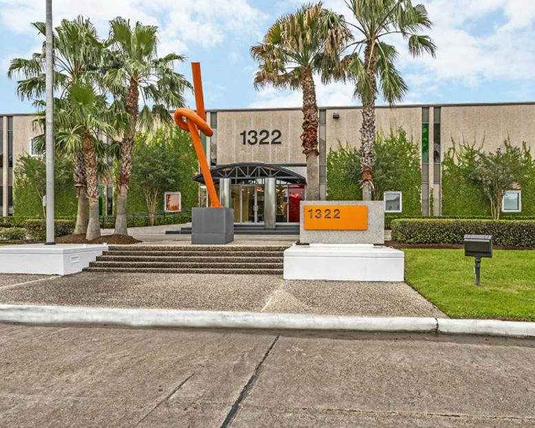 Exterior view of the office building and orange sculpture at 1322 Space Park Drive.