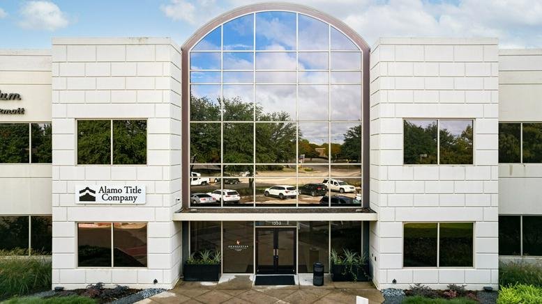 Main entrance showcasing a symmetrical facade with a grand three-story glass archway.