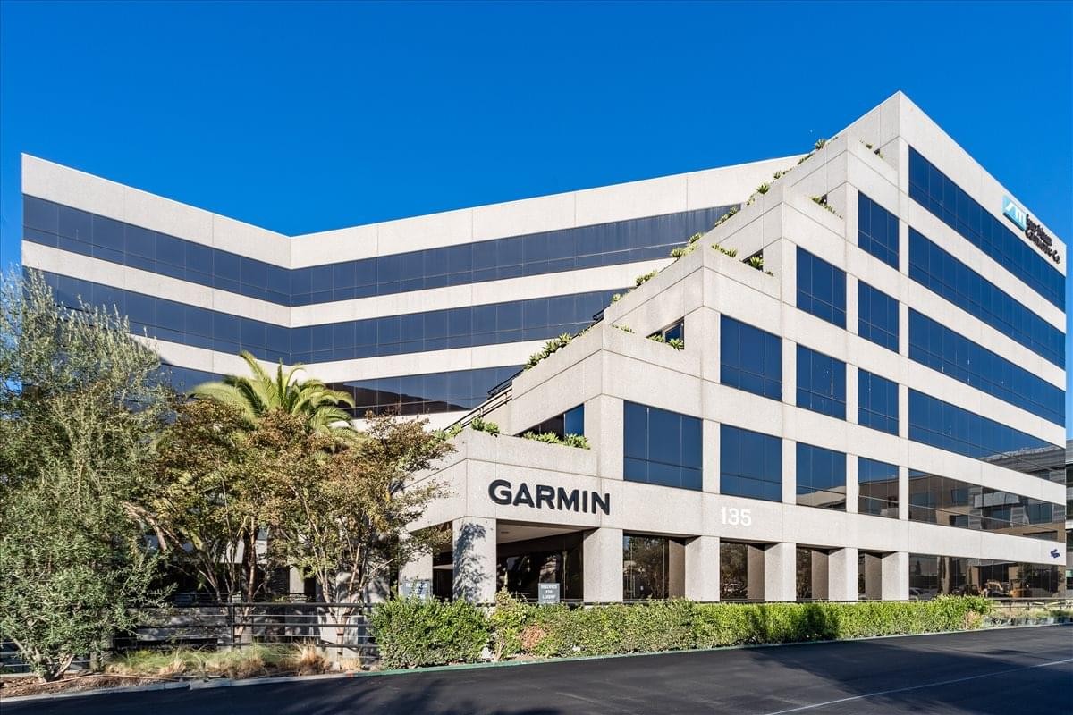 Modern multi-story office building with a unique tiered architectural design at 135 South State College Blvd.