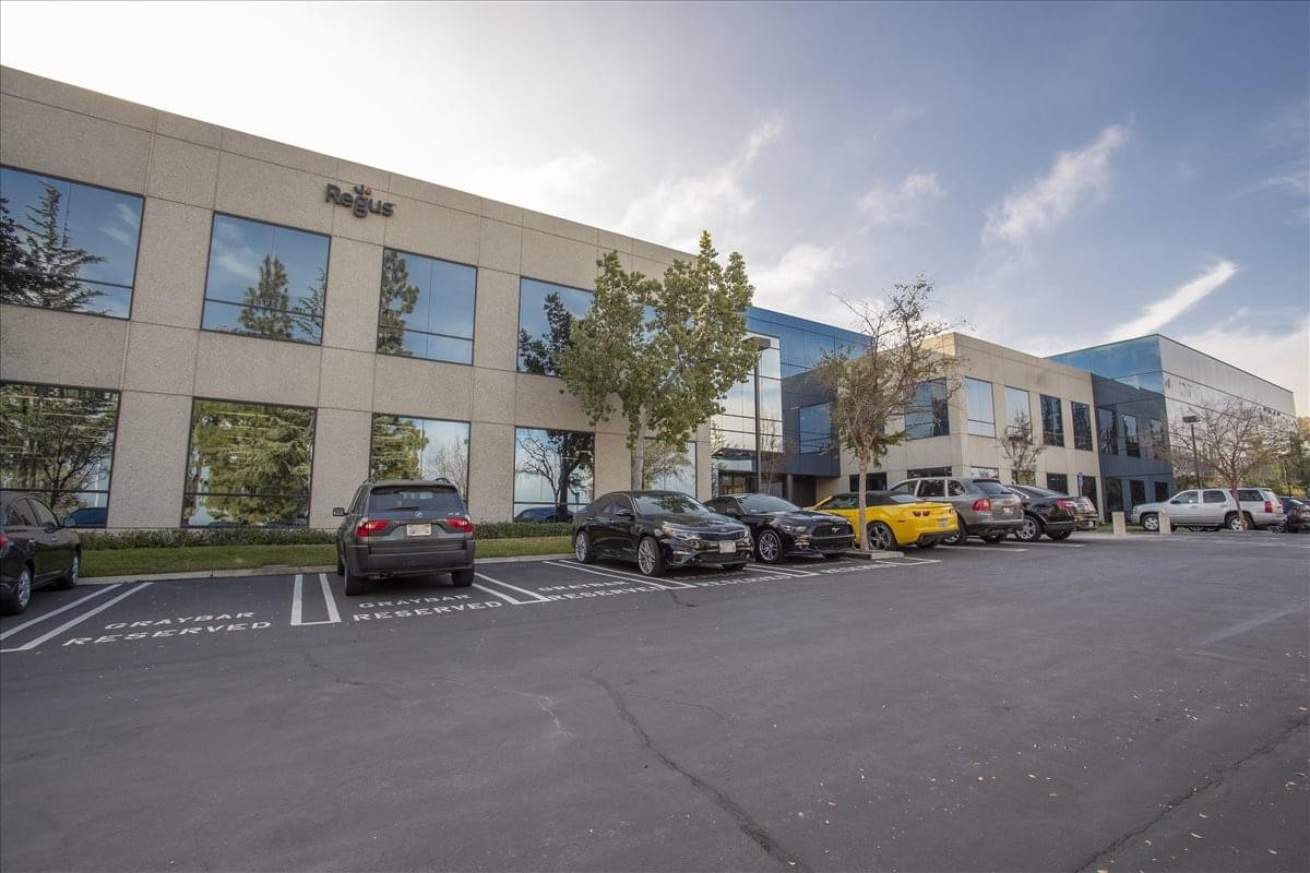Exterior view of the low-rise Gateway Centre building with parking and landscaped trees.
