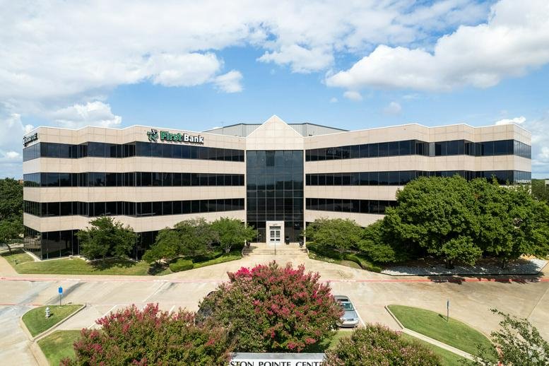 Exterior view of the multi-story stone facade at Preston Pointe Center, Plano, Texas.