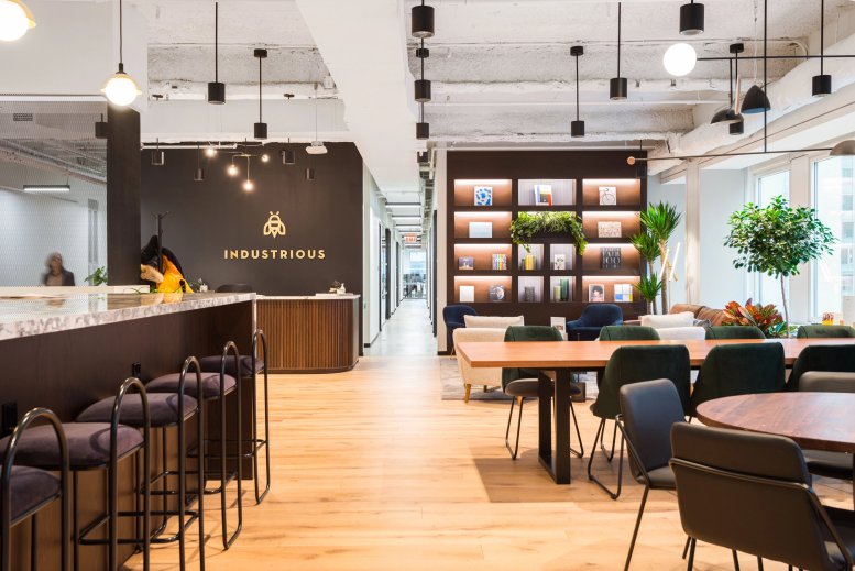 Spacious reception area and lobby at 1411 Broadway, New York City featuring a marble counter and warm wood flooring.