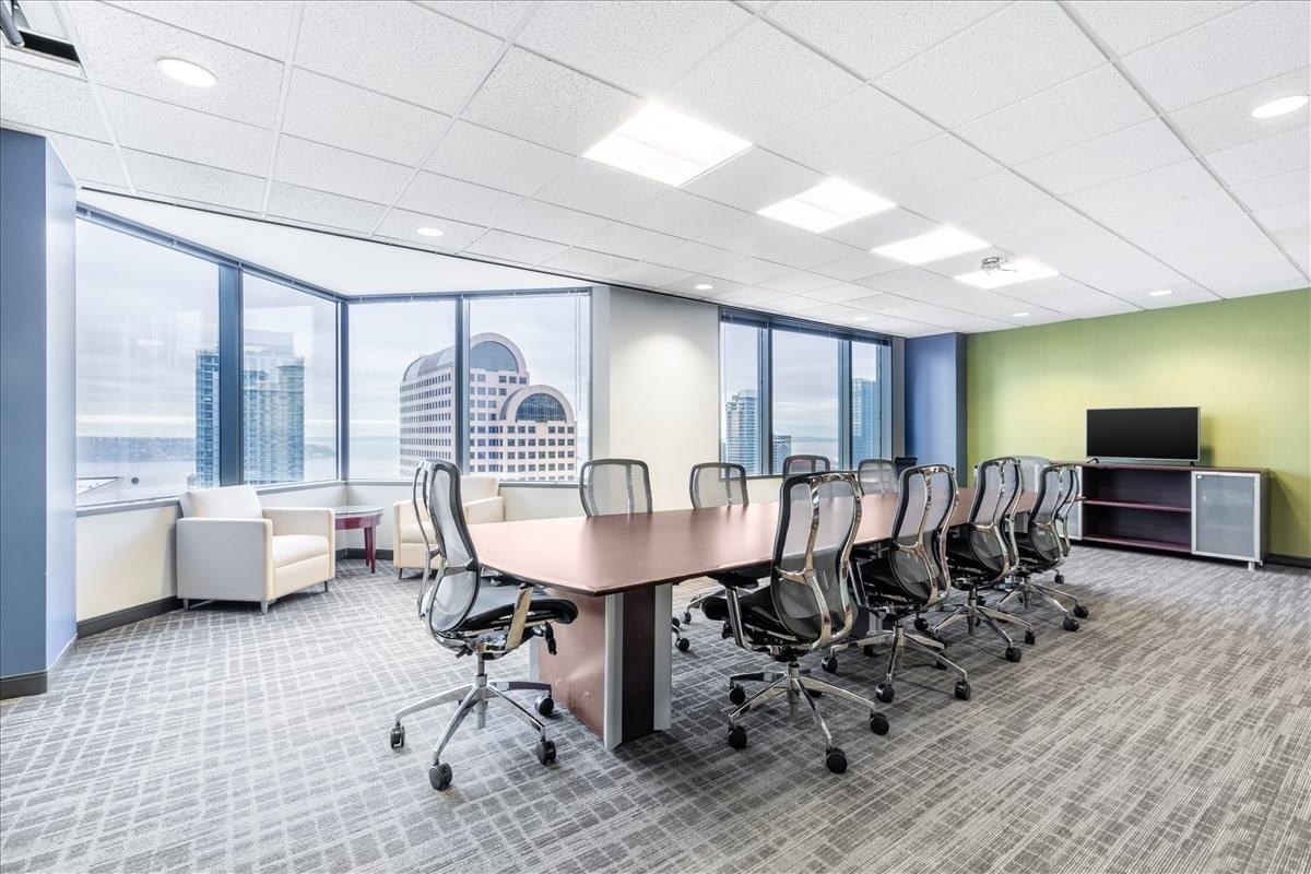 Large boardroom with expansive city views through floor-to-ceiling windows.