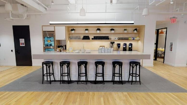 Spacious communal kitchen at 148 Lafayette Street with breakfast bar and modern appliances.