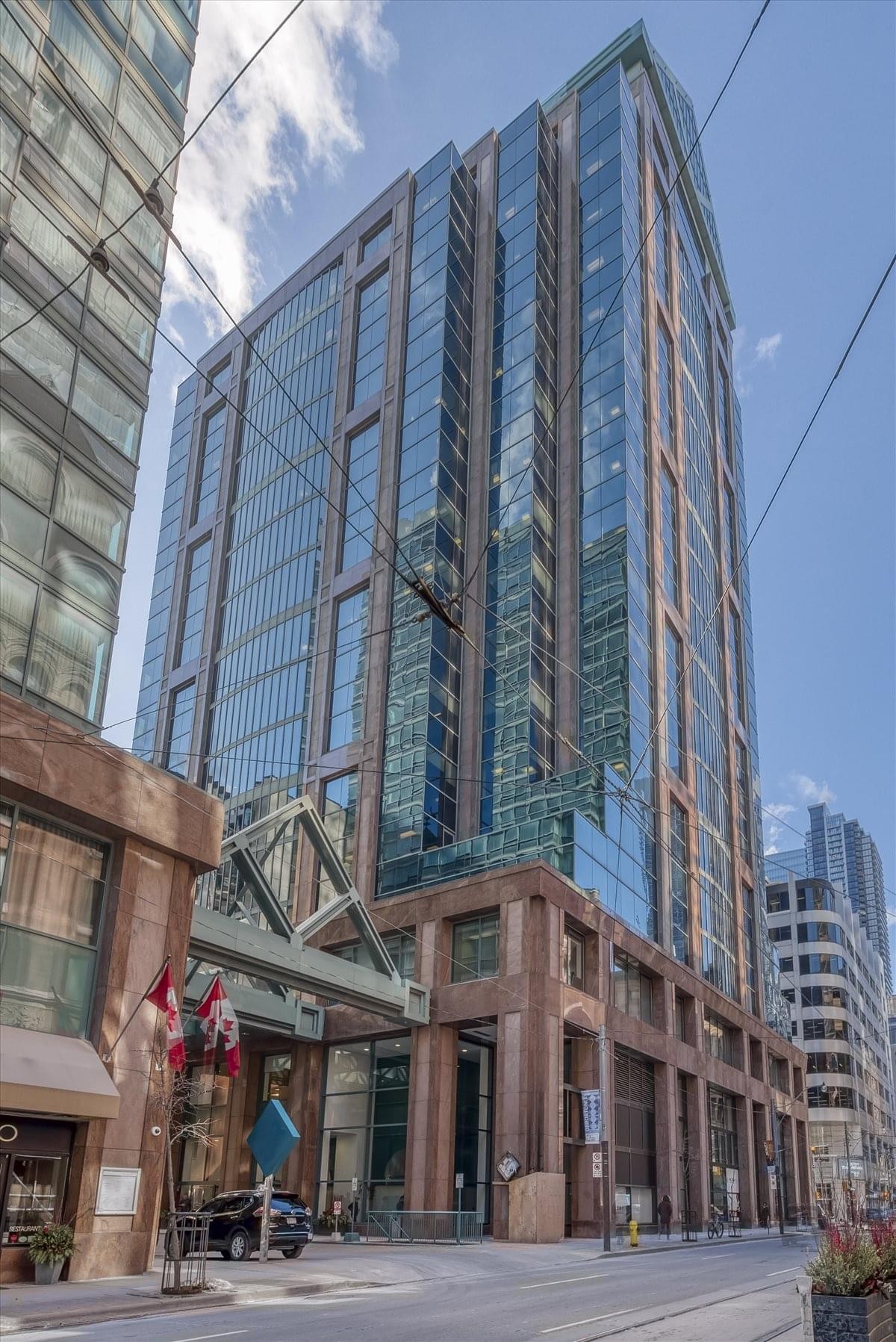 Modern open-plan workspace at 151 Yonge Street, 11th Floor, Financial District, Toronto with glass partitions and plants.