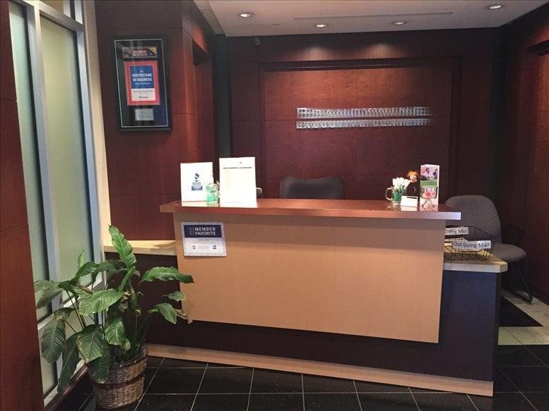 Reception area at 1521 Concord Pike, Suite 301, Wilmington featuring a wood-front desk and potted plant.