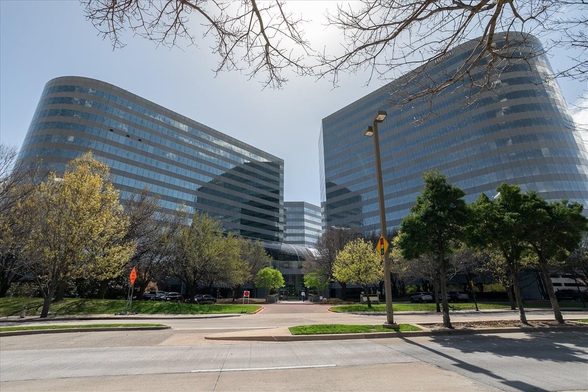 Exterior view of the curved glass facade of the Colonnade Center building.