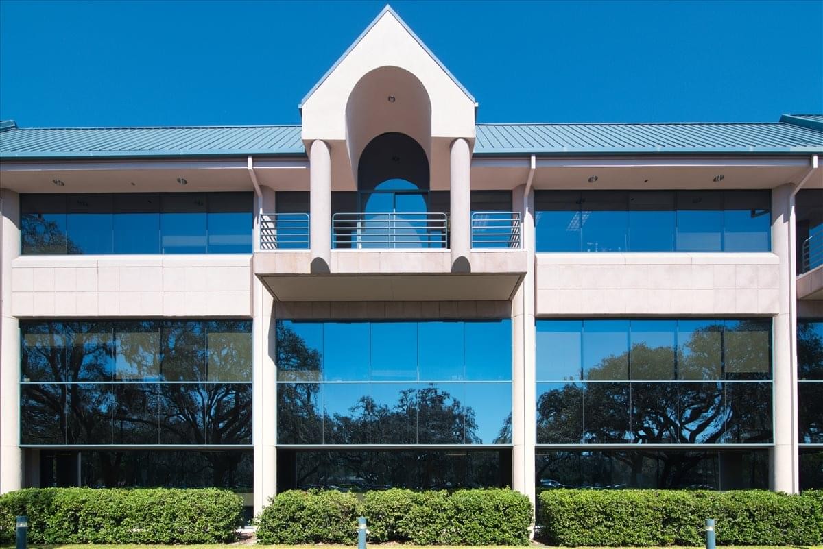 Exterior view of the office building at 15310 Amberly Drive, Suite 250 with a gabled entrance.