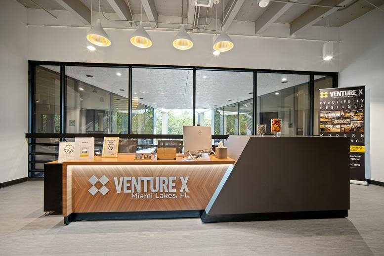 Modern branded reception area for Venture X, Suite 200, 15450 New Barn Road, Miami Lakes, Florida.
