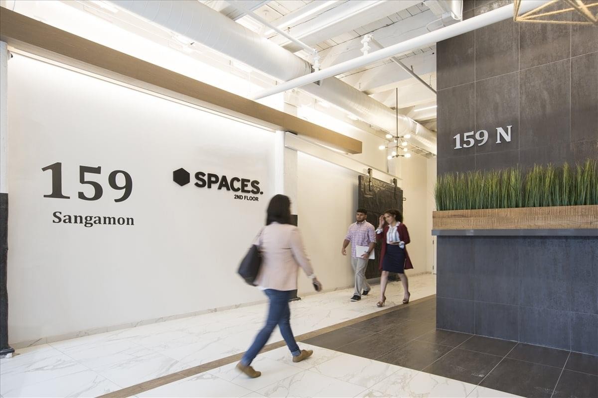 Spacious reception lobby at 159 N. Sangamon Street, Suite 200 & 300, with branded signage and modern lighting.