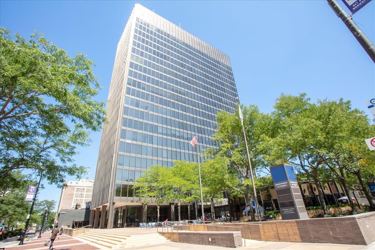 Exterior view of the high-rise Orrington Plaza Centre building against a clear blue sky.