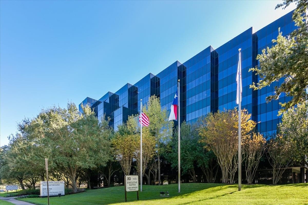 Exterior view of the glass-facade 16225 Park Ten Place building with a manicured lawn.