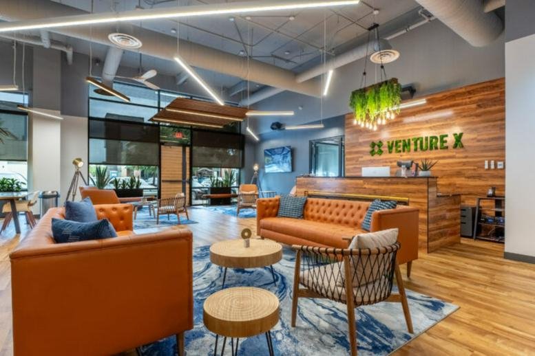 Warm reception area at Fairview Town Center with a wooden front desk and orange leather seating.