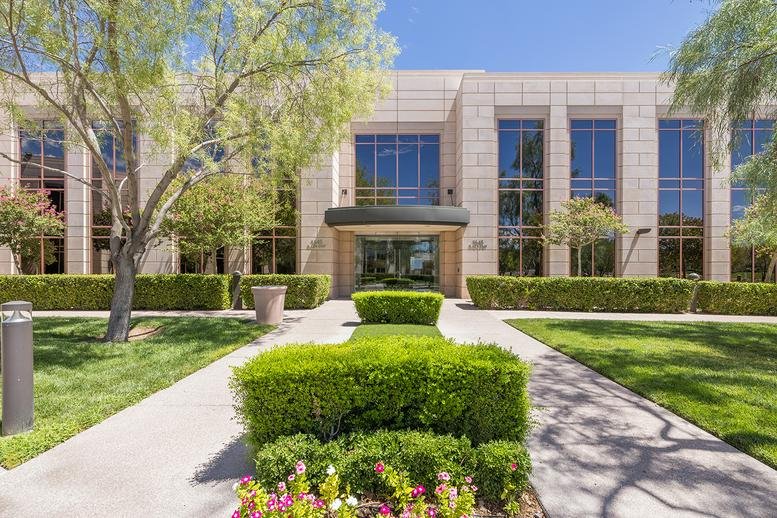 Exterior entrance of OFFICENEST Summerlin, Village Center Circle with manicured gardens.