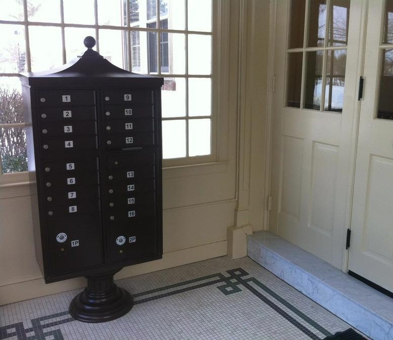 Lobby area with vintage dark wood mailboxes and natural light from large windows at 1669 Edgewood Road.