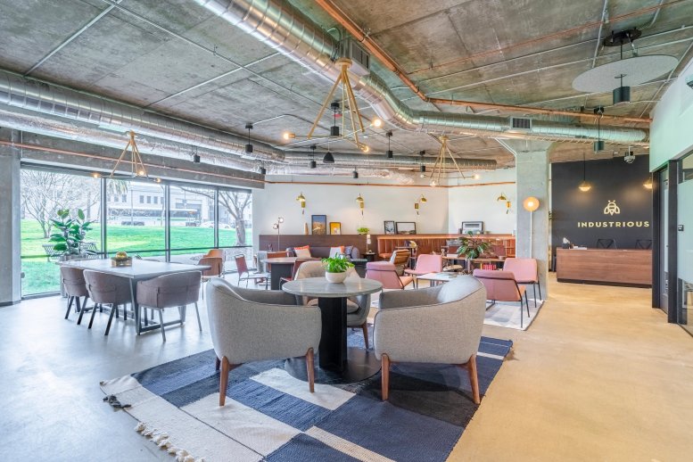 Spacious communal lounge at 1700 Montgomery St with diverse seating and industrial ceilings.