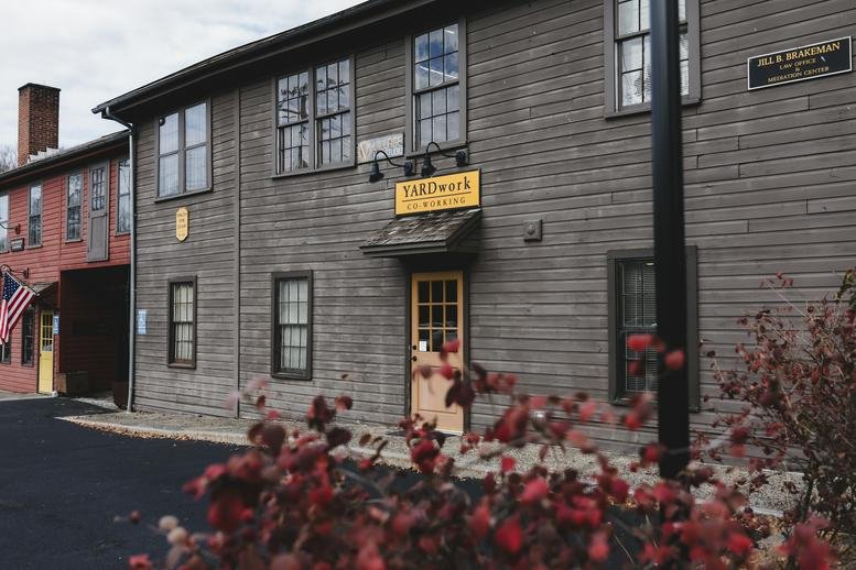 Exterior view of the rustic wooden facade and entrance at 174 West Street, Suite 113, Litchfield, Connecticut.