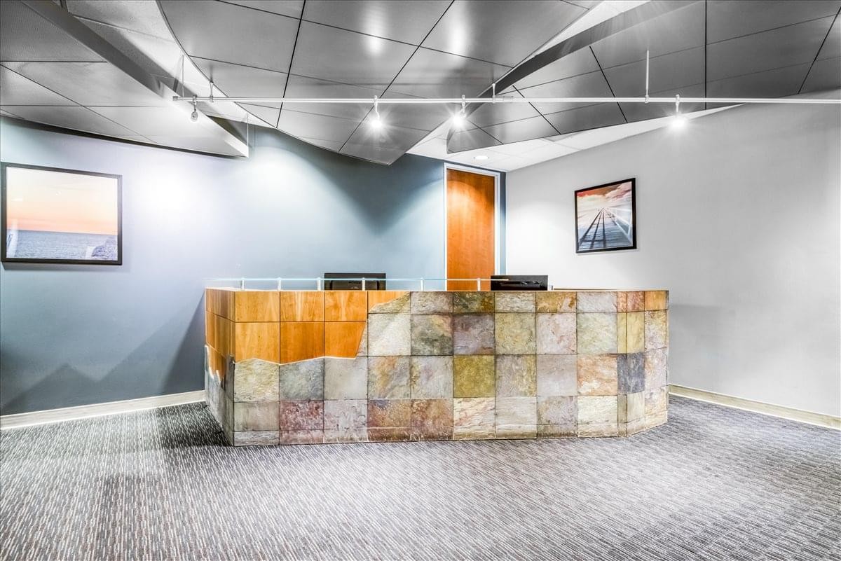 Modern reception area at 1745 Shea Center Drive, Suite 400 with a textured stone desk.