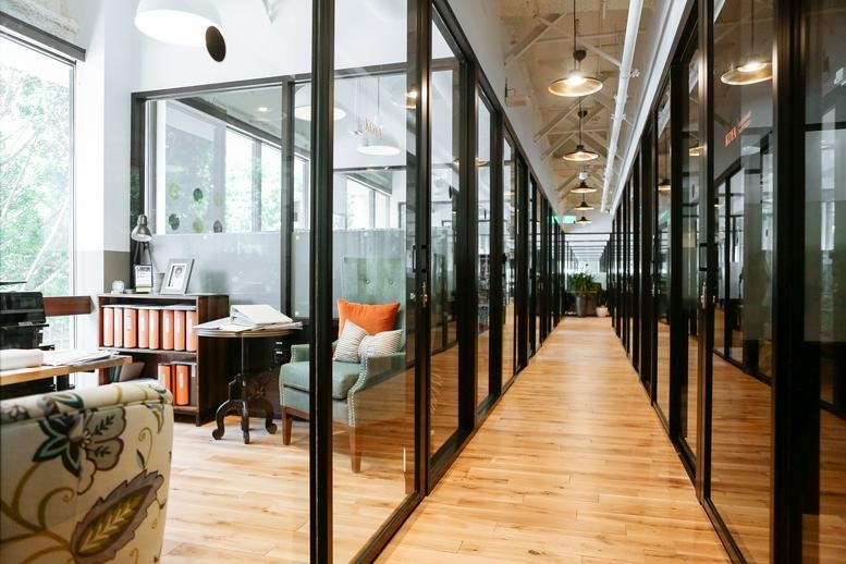 Spacious glass-walled corridor with wood floors at 177 East Colorado Blvd.