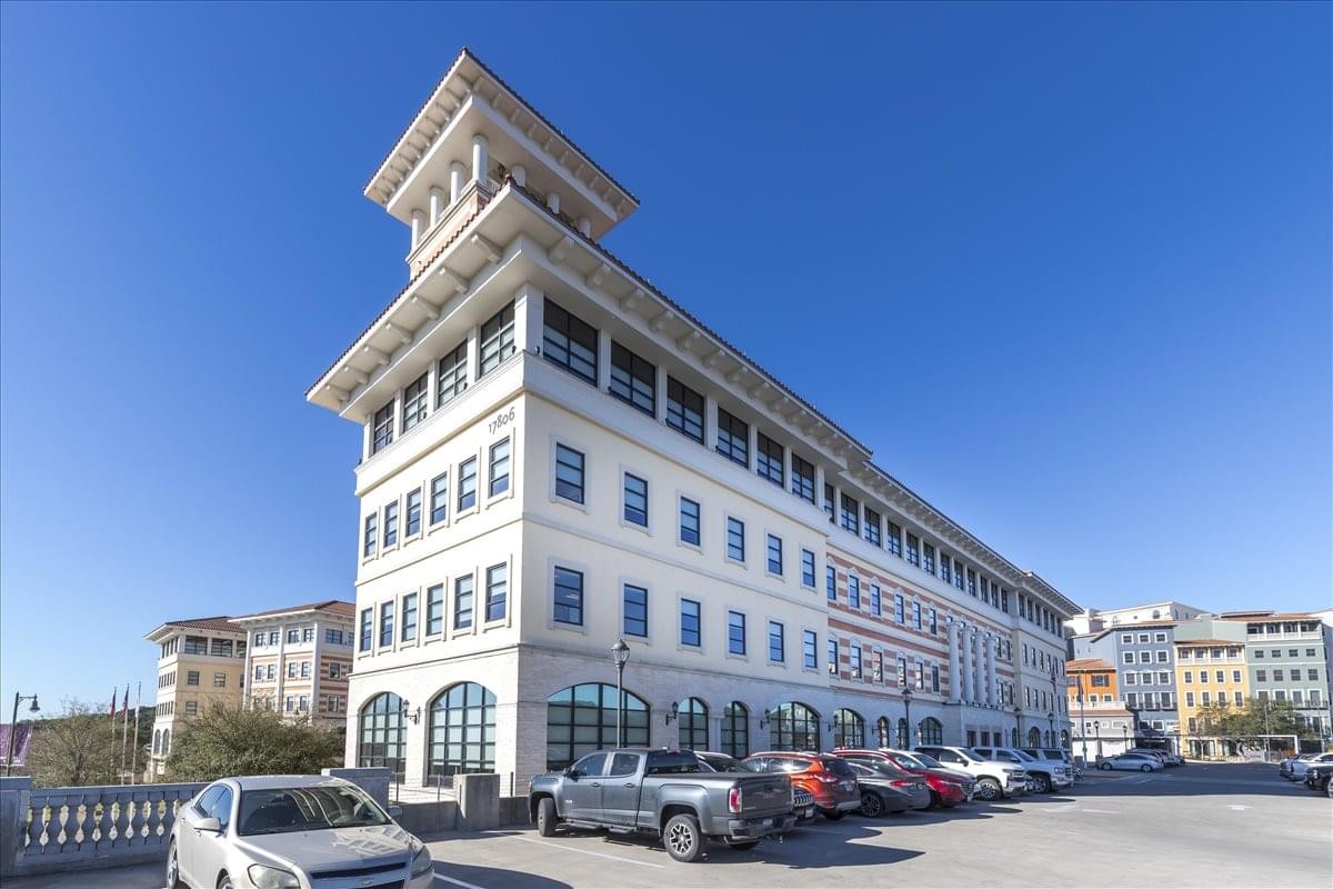 Exterior view of the white tiered building at 17806 Interstate Highway 10.