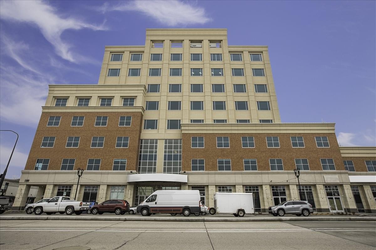 Exterior view of the multi-story stone and brick building at 180 North University Avenue.