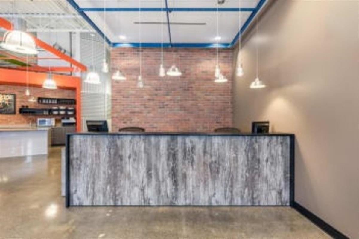 Reception area at 180 Northfield Drive West, Unit 4, 1st Floor, Waterloo Centre featuring a rustic brick accent wall.