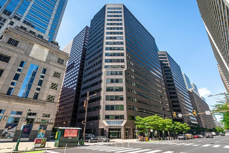 Exterior view of the high-rise office building at 1800 JFK Boulevard with a modern glass and stone facade.