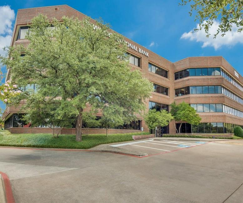 Exterior view of the brick facade and lush trees at 1801 N Hampton Road.