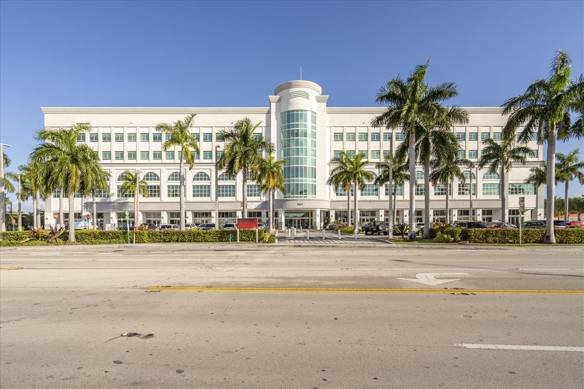 Exterior view of the grand facade and palm trees at Causeway Square Business Centre.