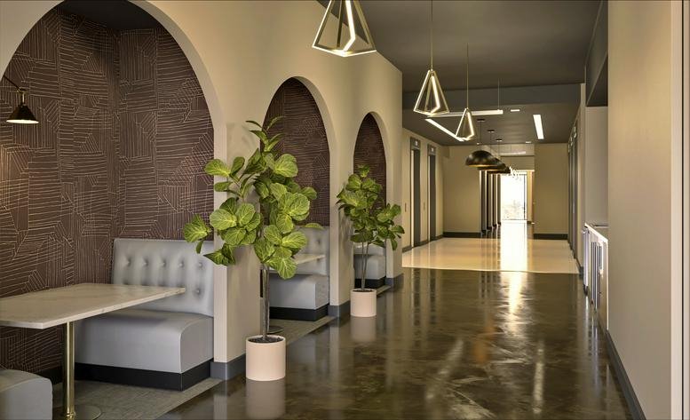 Spacious corridor at 1801 West End Avenue featuring arched alcoves with dining booths and potted plants.