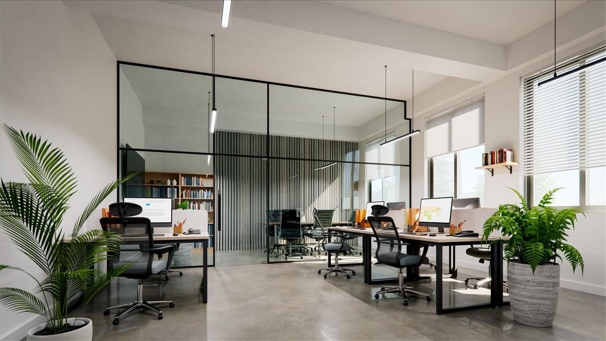 Modern open-plan workspace at West Point Commons with glass partitions and indoor plants.