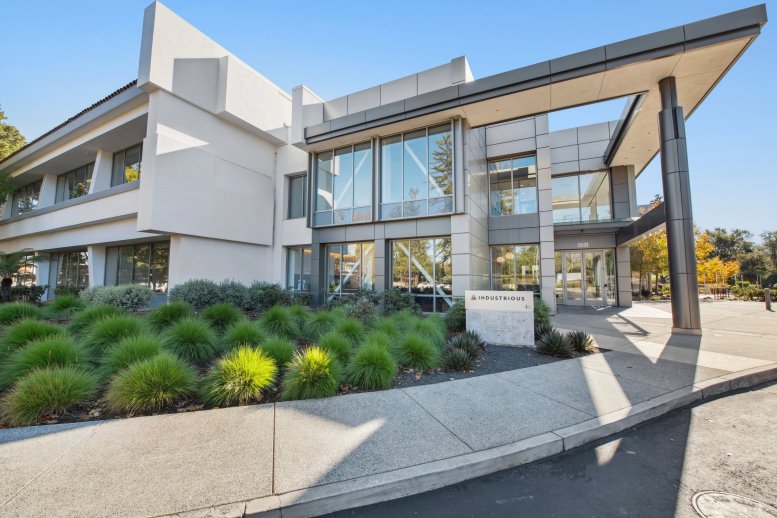 Exterior view of the modern glass and metal facade at Industrious Palo Alto Page Mill.