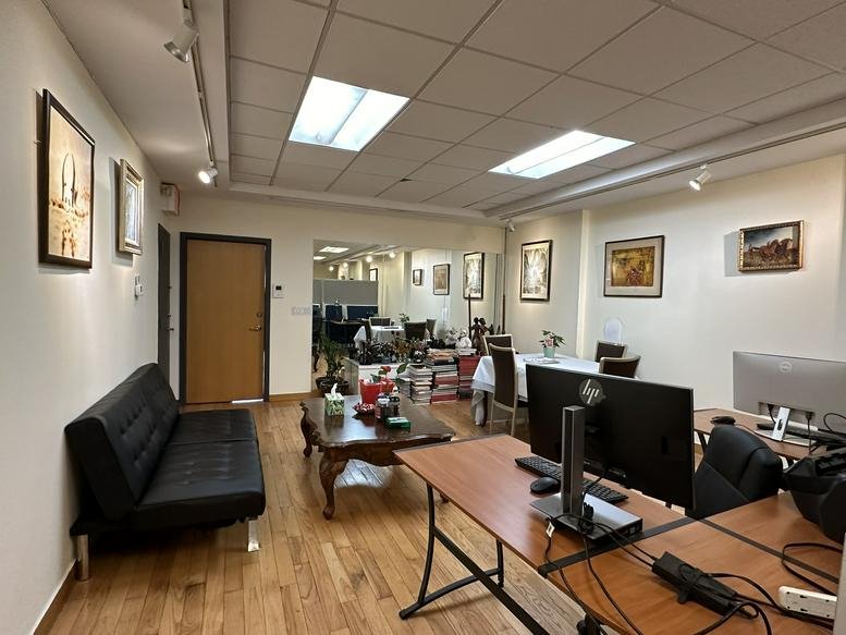 Spacious office suite at 19 West 26th Street, Suite 503, featuring wood floors, a sofa, and multiple workstations.