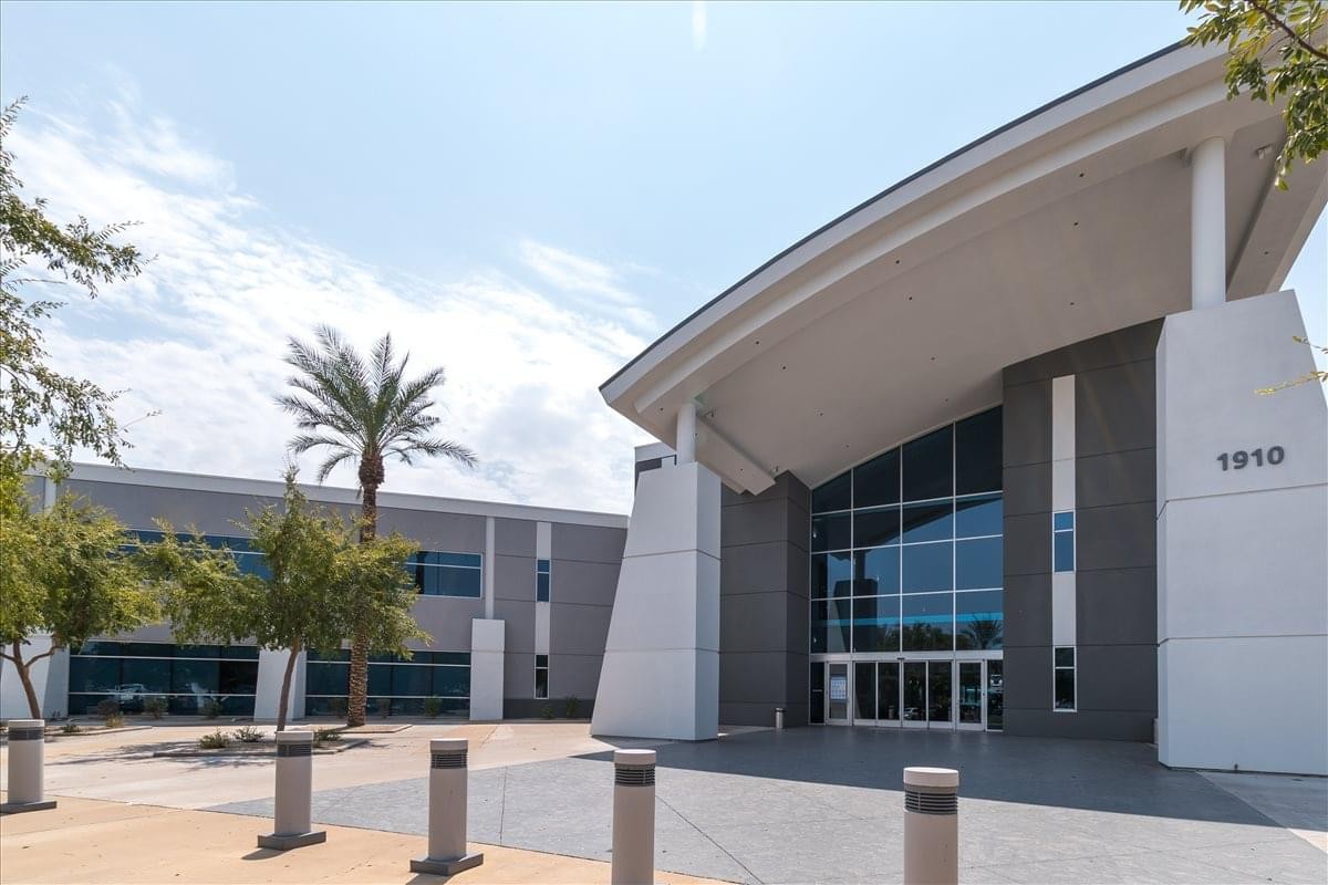 Exterior view of the modern glass entrance at Stapley Corporate Center.