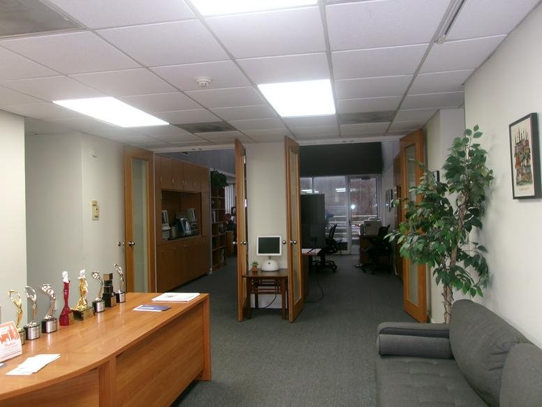 Bright reception area for 1912 E NC Hwy 54, Suites C & C2, RTP, Durham, North Carolina with wooden desk and sofa.
