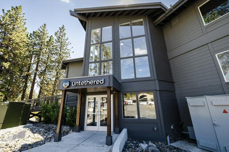 Exterior view of the wood and glass entrance at Untethered Workspace.