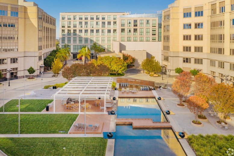 Exterior courtyard view of 1950 University Avenue with reflecting pools and modern office buildings.